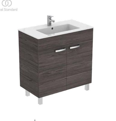 the bathroom vanity is made of wood and has a white counter top