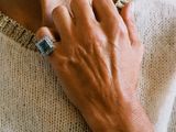 a woman that is wearing a ring on her neck