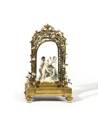 a figurine of a man and a woman in a gold frame