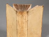 an old book sitting on top of a table next to a cup of coffee
