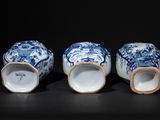three blue and white vases sitting next to each other on a table