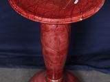 an image of a red table with a wooden base