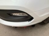 a close up of a white car with a black bumper