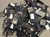 a pile of men ' s black pants with tags on them