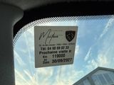 a picture of a car window with a sign attached to it