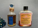two bottles of perfume sitting next to each other on a table