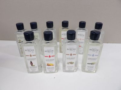 six bottles of cologne sitting on top of a white table