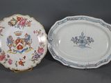 two plates with designs on them sitting side by side on a table
