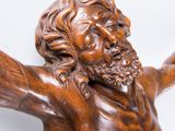 sculpture of a man with a beard holding his arms out in the air