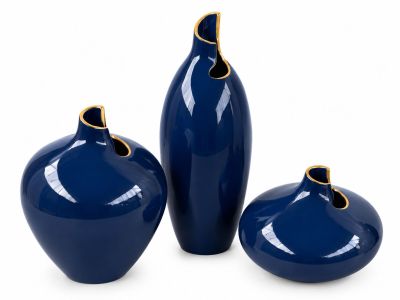 three blue vases sitting next to each other on a white surface