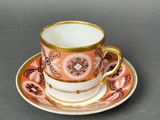 a cup and saucer on a saucer on a table