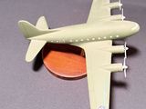 a toy airplane that is sitting on top of a coin