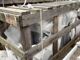 several pallets of wood are stacked on top of each other in a warehouse