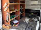 a white van that has some tools in the back of it