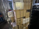 many boxes stacked on top of each other in a metal cart