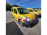several yellow vans parked in a parking lot next to each other