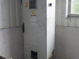 a white refrigerator sitting in a room next to a window