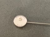 a close up of a button with a pin on it