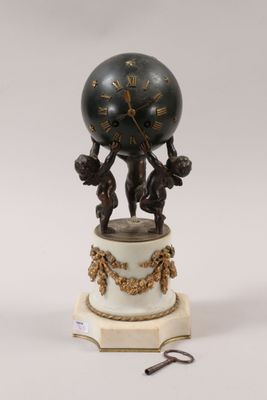 a clock that is on top of a marble pedestal