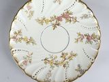 a plate with a floral design on it on a table