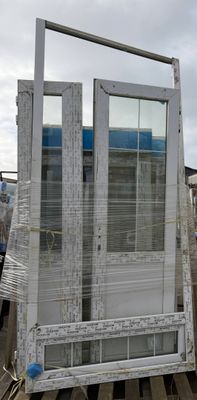 a white door sitting on top of a pallet next to a truck