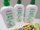 three bottles of baby lotion sitting on a counter next to a tube of love and green baby lotion
