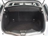 the back of a car with its trunk open and luggage in the trunk