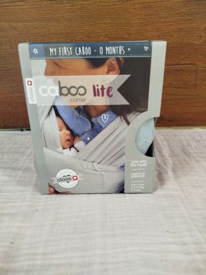 the box of the baby carrier is open on the bed