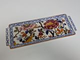 an image of a decorative tray with flowers and birds painted on it
