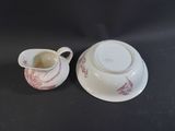 a small cup and saucer sitting on a table
