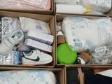 a box full of baby items that are sitting on the floor