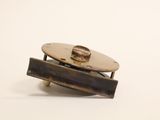 a close up of a small metal object on a white surface