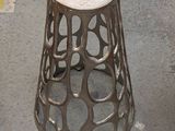a metal stool with a hole in the middle of it
