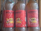 three bottles of orange juice sitting on a shelf