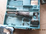 a small tool in a blue case on the floor
