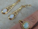 an image of a woman ' s hand with a ring and earrings