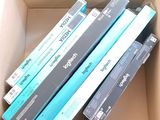 several books are stacked in a cardboard box on top of each other