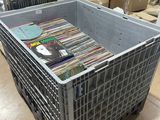 a large metal crate with many books inside of it