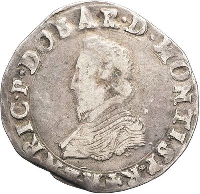 a silver coin with an image of a man on it