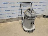 the vacuum is sitting on the floor in front of the wall