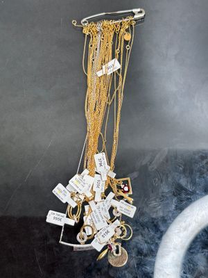 a picture of a necklace hanging from a hook on the wall