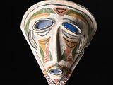 a close up of a decorative mask on a black background