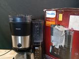 a coffee maker and a blender sitting on a table