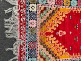 rug on the ground with a red and yellow design on it