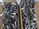 two boxes of television remotes sitting on a table