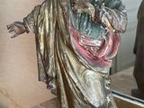 a statue of a man holding a baby in his arms