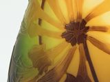 a glass vase with a yellow and green design on it