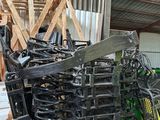 a pile of junk in a warehouse next to a pile of pallets