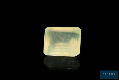 an image of a yellow jade stone on a black surface