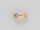 a gold ring with pink stones and diamonds